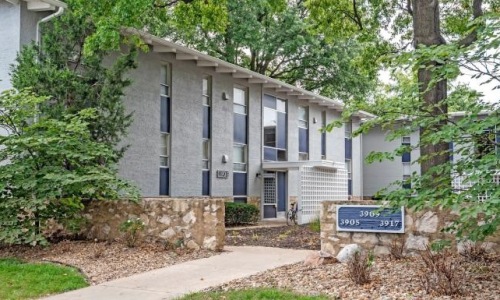 The exterior of a building near a wooded area
