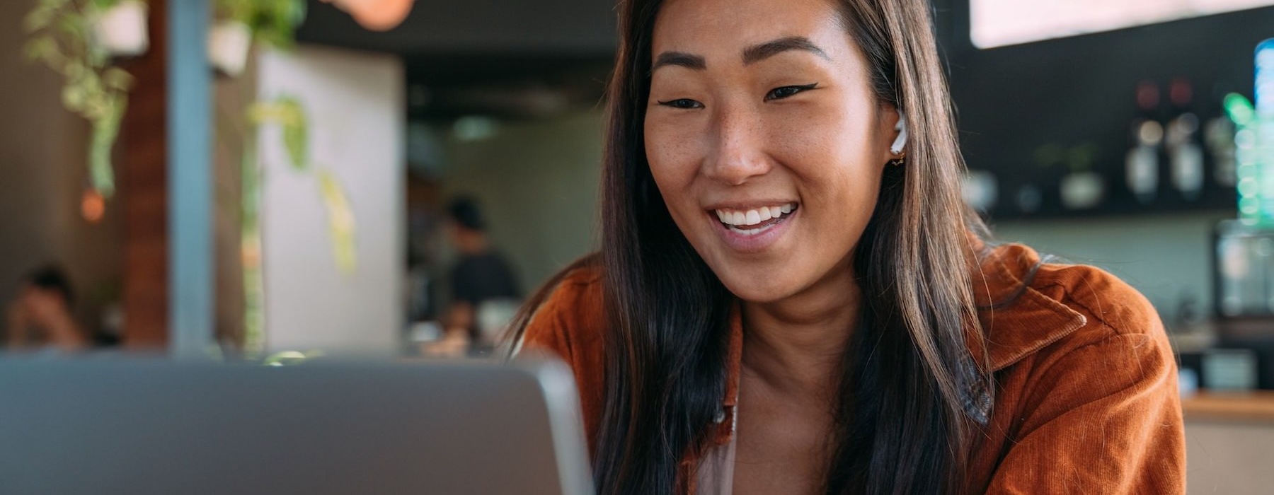 a woman smiling at the computer