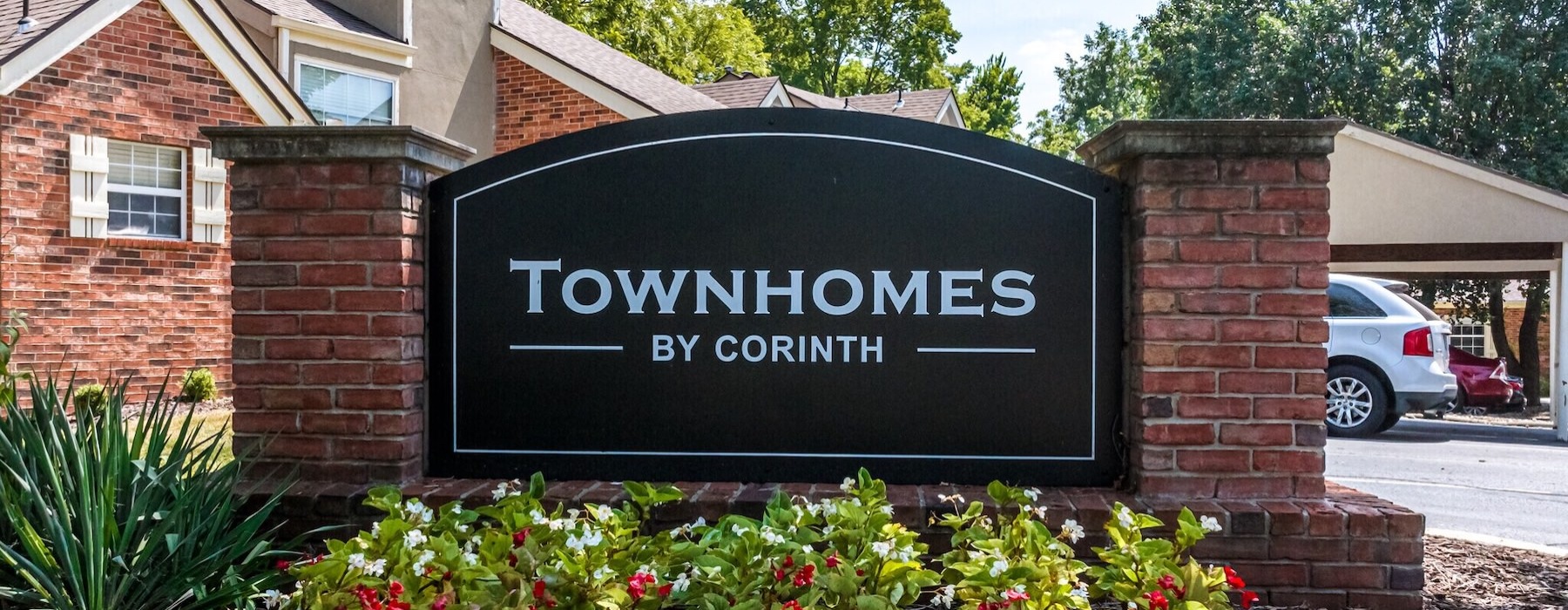 a sign in front of a brick building